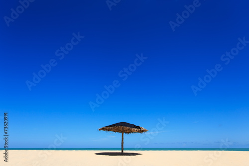 Wooden sun umbrella on the beach in Thailand