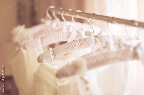 Beautiful white wedding dresses made of silk on hangers
