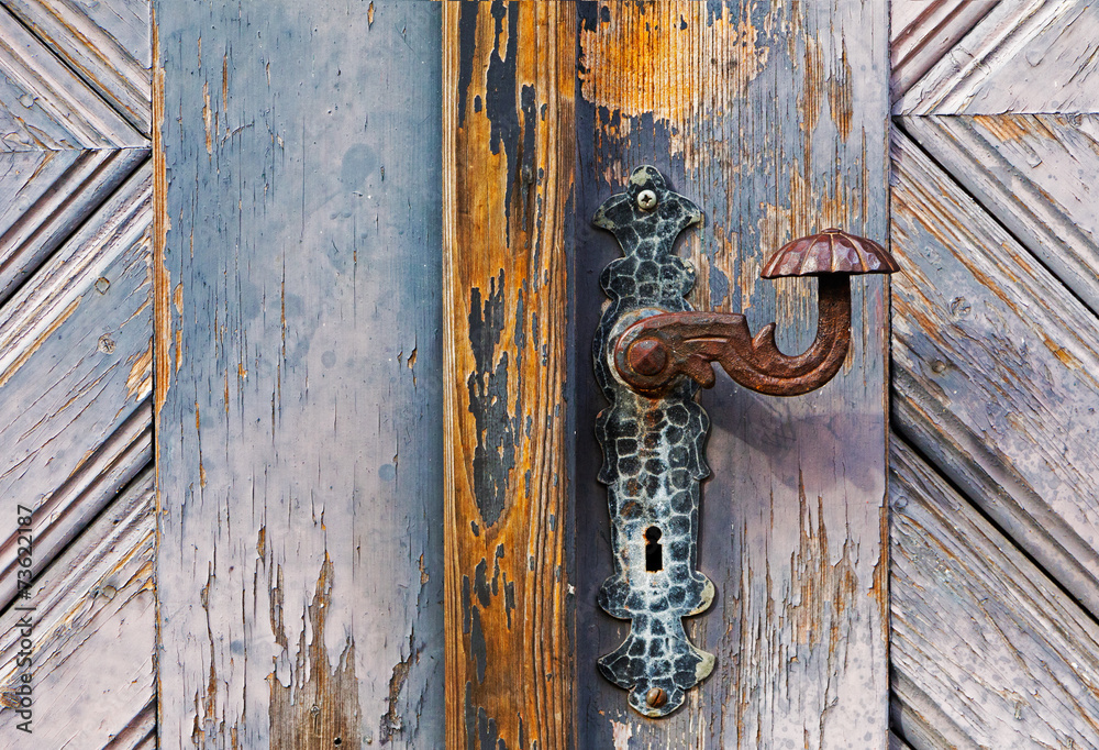 Iron door handle on the old wooden door Iron door handle on the old wooden door