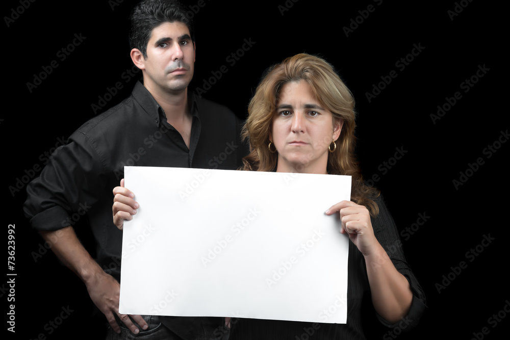 Woman and man holding a white banner isolated on black Woman and man holding a white banner isolated on black