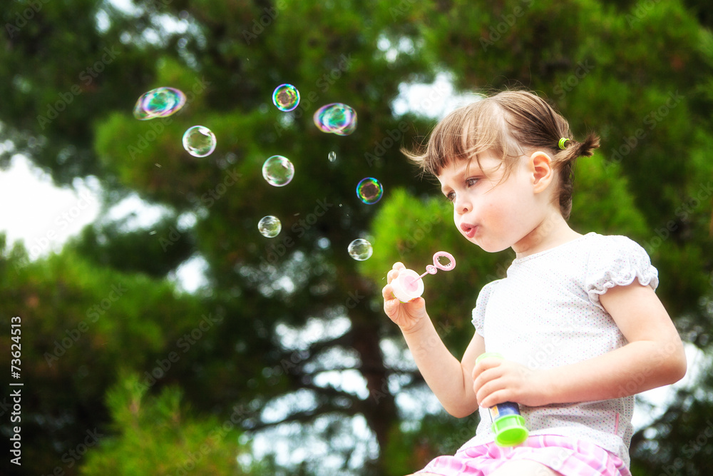 little girl blowing soap bubbles little girl blowing soap bubbles