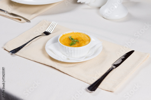 Bowl of pumpkin soup served at table