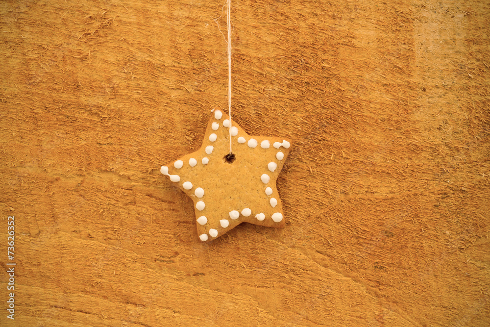 Christmas cookies hanging over wooden background