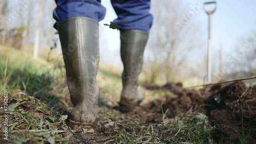 Close up of Gardener shoes going to the garden in slow motion