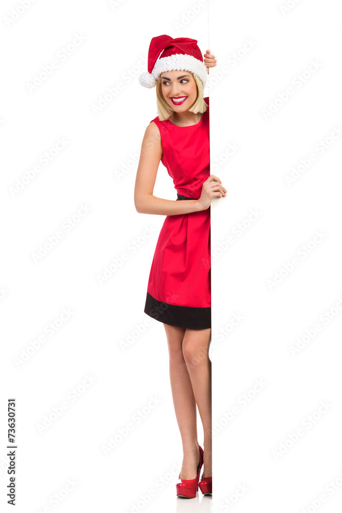 Smiling Santa Girl behind big white copy space Smiling Santa Girl behind big white copy space