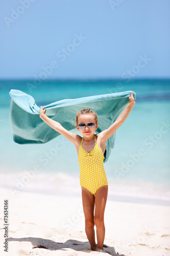 Cute little girl having fun on beach vacation