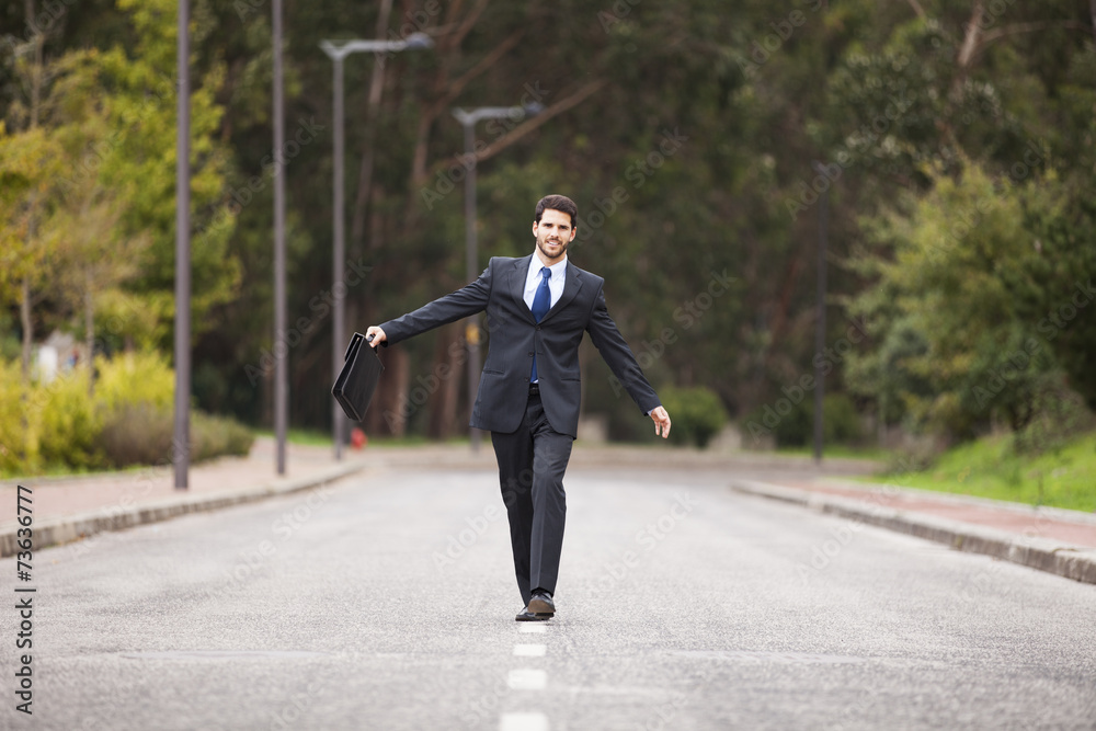 Businessman walking on the road line