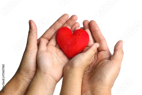 mother and a child holding a red heart together