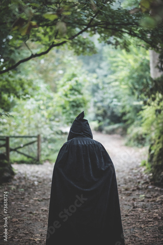 beautiful dark vampire woman with black mantle and hood