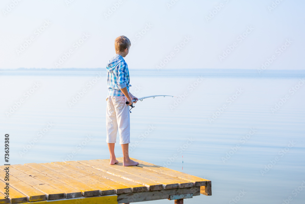 Boy in blue shirt standing on a pie Boy in blue shirt standing on a pie