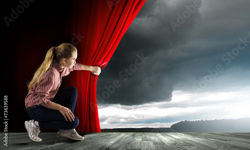 Girl opening curtain