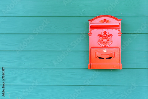 Canvas Print Red mailbox with green wood background