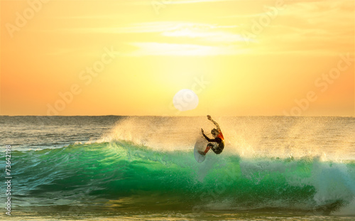 Surfer Surfing at Sunrise