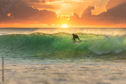 Surfer Surfing at Sunrise photo