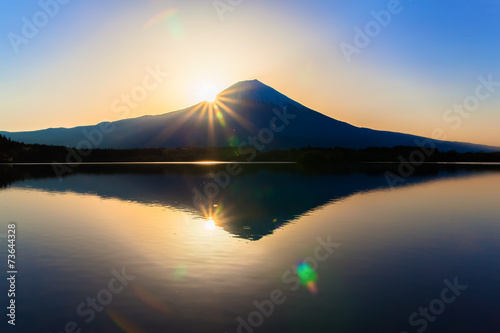 Sun shine and inverted Mount Fuji reflected in Lake Tanukiko