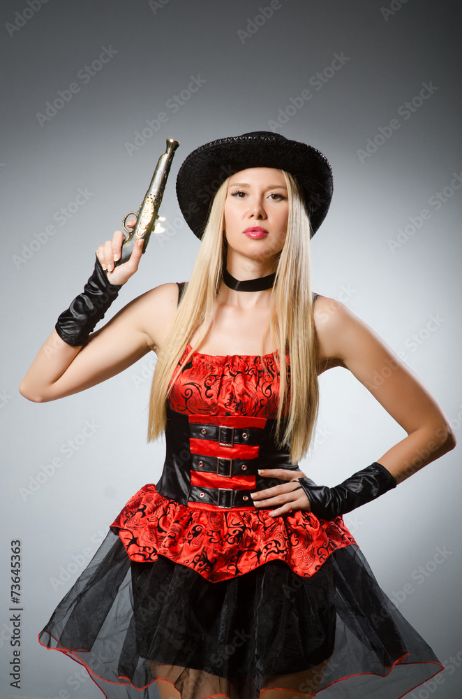 Woman pirate with gun wearing hat
