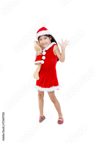 Portrait of little Asian girl in red Santa hat finger up