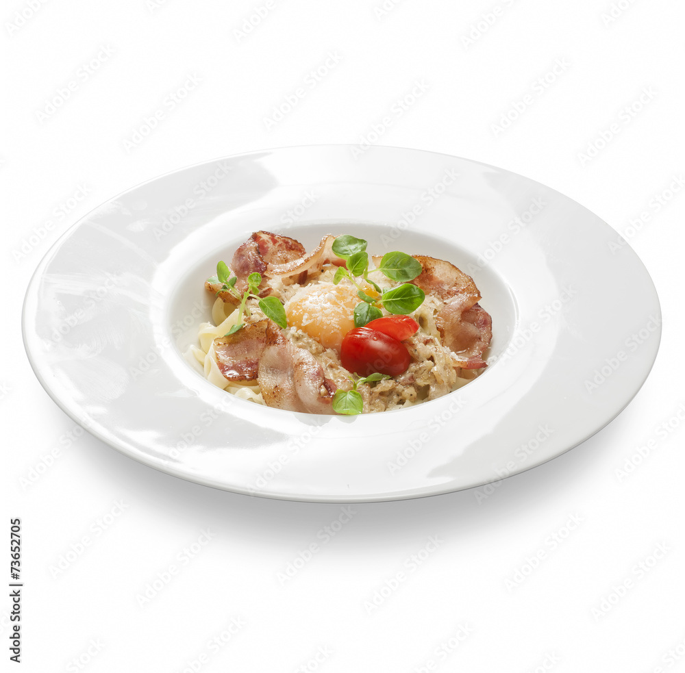 Freshly cooked pasta with salami, ham egg and cheese on a plate Freshly cooked pasta with salami, ham egg and cheese on a plate
