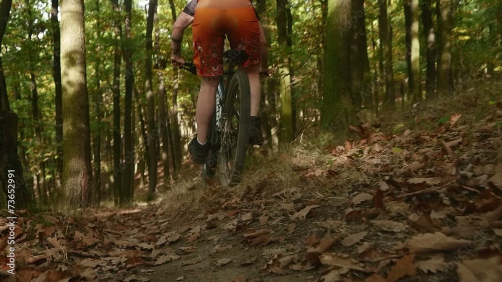 Young girl in helmet riding fast on her mountain bicycle slow
