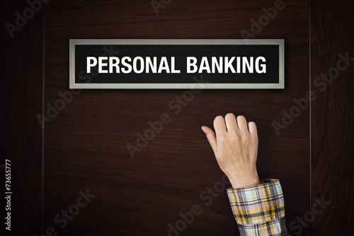 Hand is knocking on Personal banking door photo