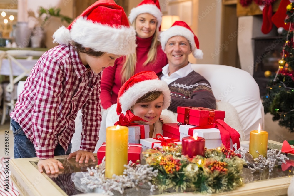 Smiling family at christmas time with lots of presents Smiling family at christmas time with lots of presents