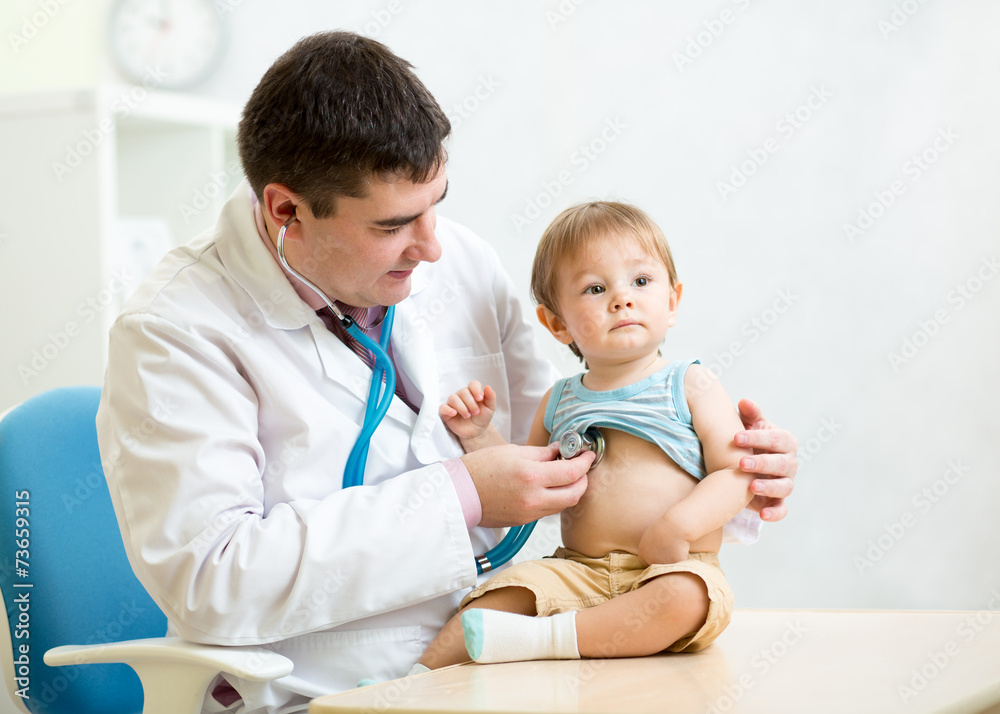 doctor examining heartbeat of kid boy with stethoscope doctor examining heartbeat of kid boy with stethoscope