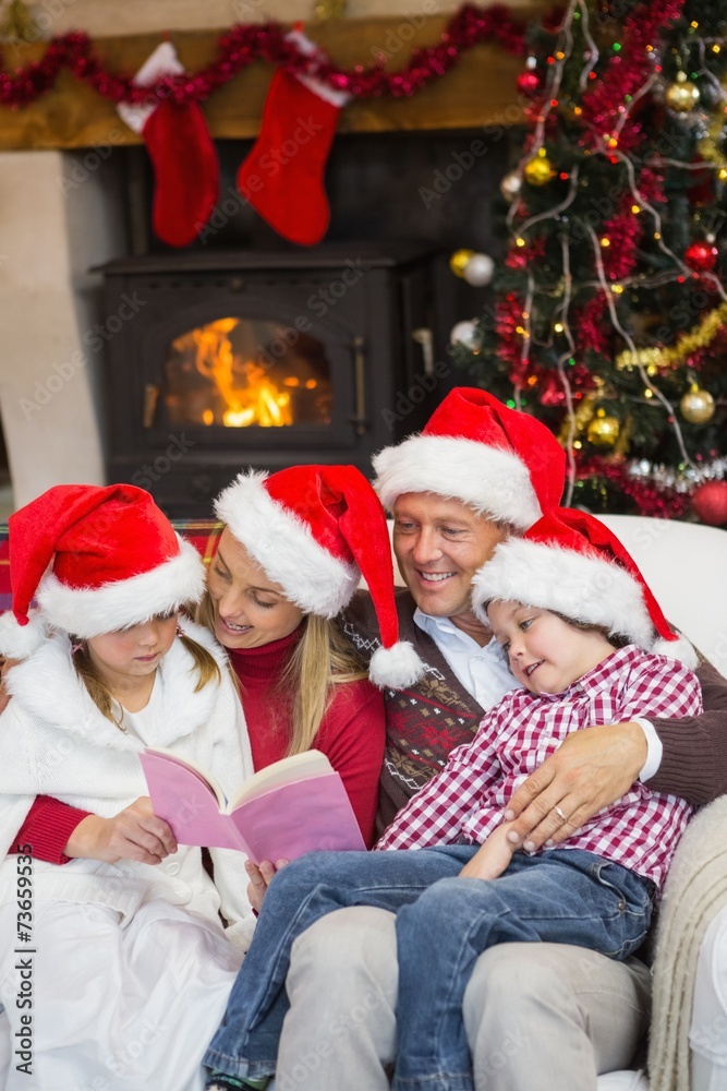 Happy family reading at christmas Happy family reading at christmas