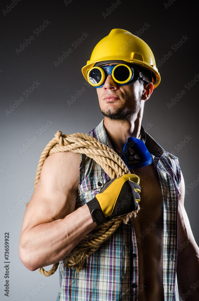 Fototapeta premium Ripped muscular builder man with tools