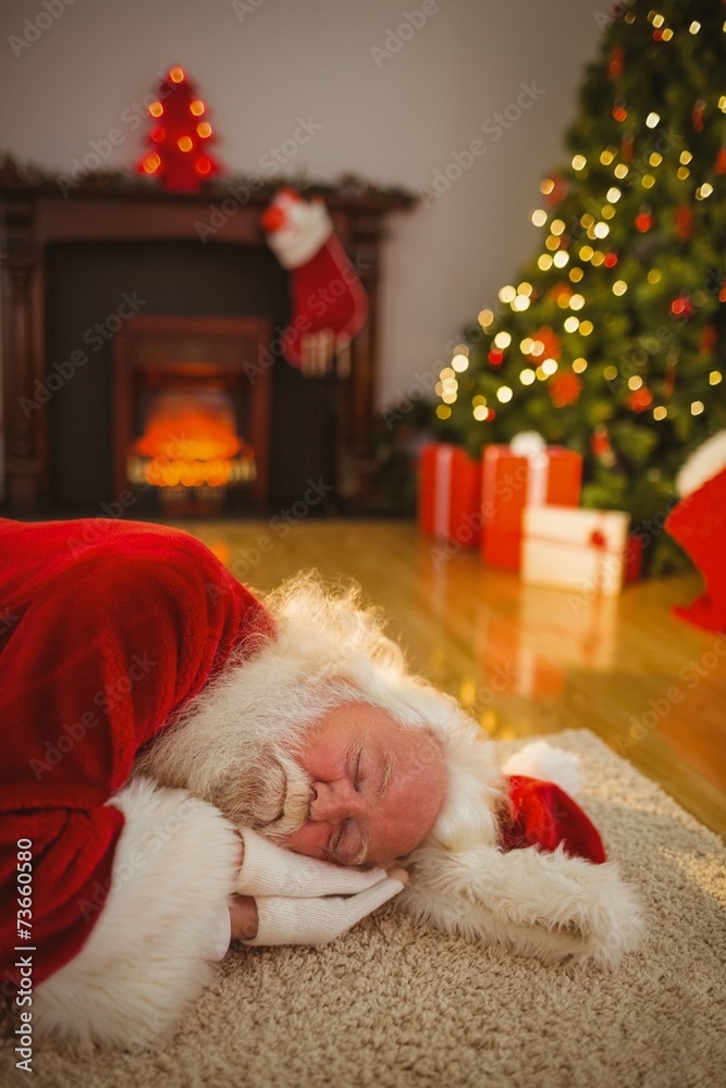 Obraz premium Santa claus napping on the rug