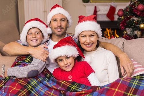 Festive family hugging under the cover