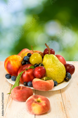image of various fruits on a table on green background