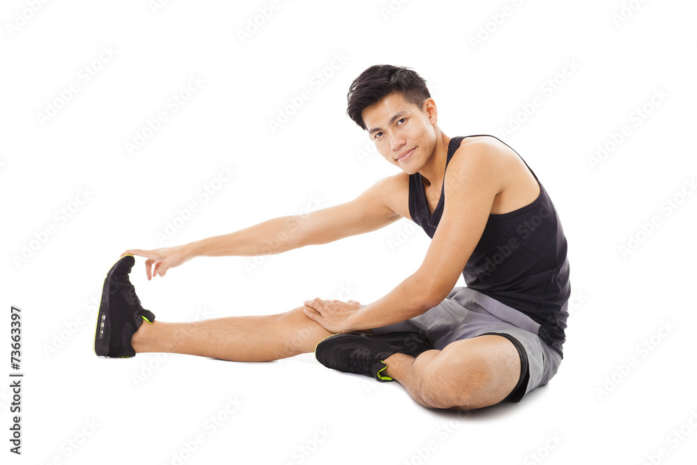 fitness man sitting and making stretching exercises fitness man sitting and making stretching exercises