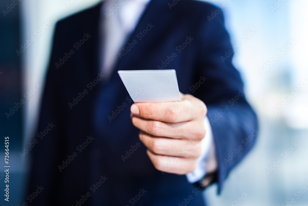 Businessman giving a business card Businessman giving a business card