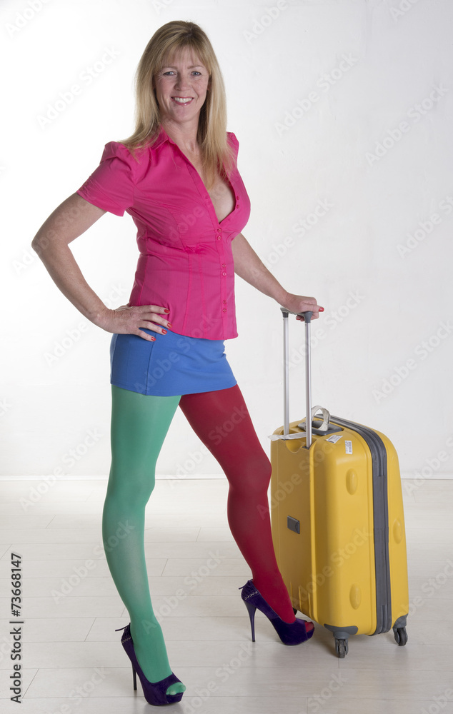 Woman wearing multicolored clothes and travel luggage Woman wearing multicolored clothes and travel luggage