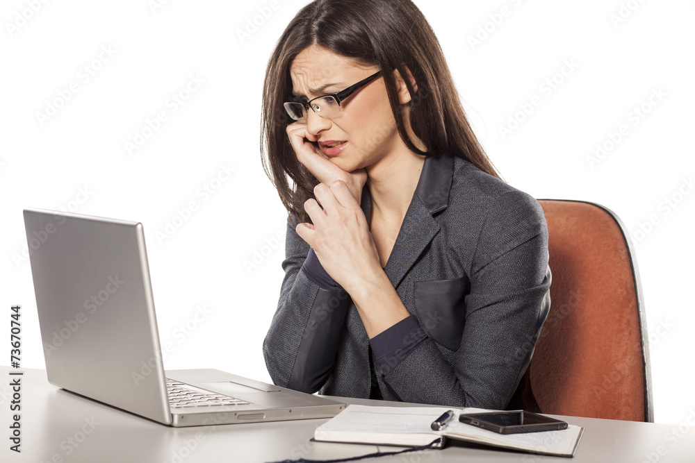 confused young businesswoman looking in her laptop confused young businesswoman looking in her laptop