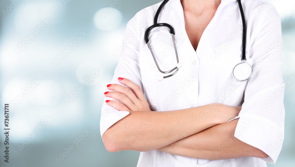Doctor with stethoscope on hospital background Doctor with stethoscope on hospital background