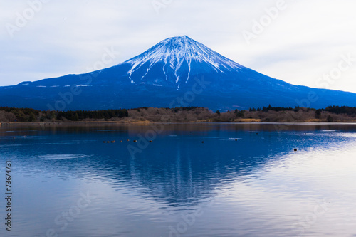 Sun shine and inverted Mount Fuji reflected in Lake Tanukiko