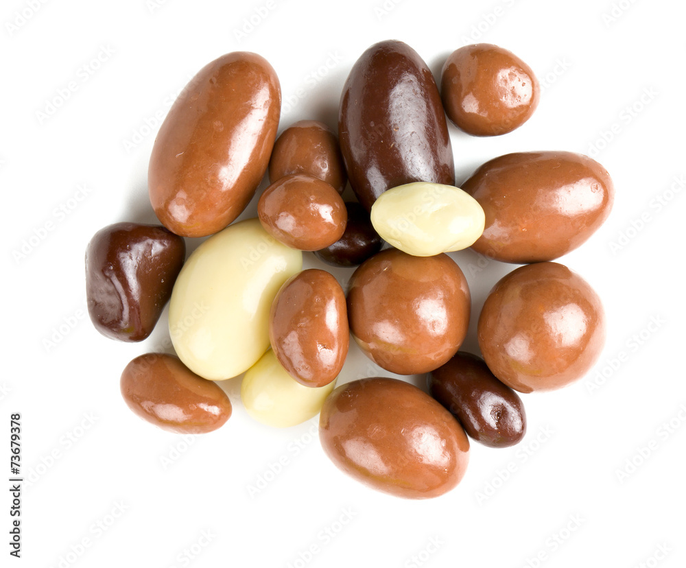 chocolate covered nuts and raisins isolated on white chocolate covered nuts and raisins isolated on white