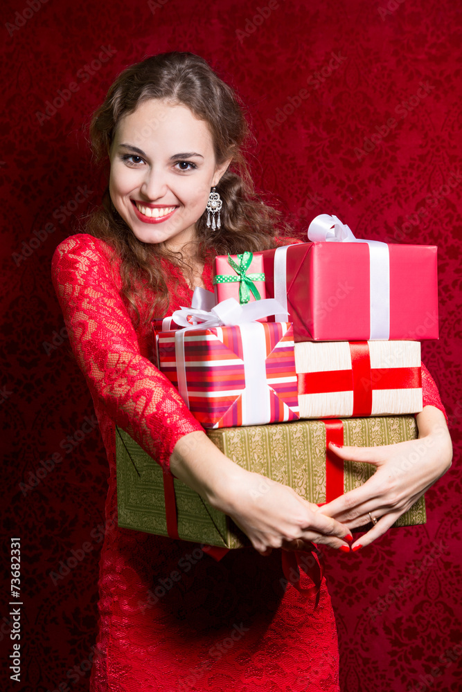 Happy girl in red dress with gift box. Happy girl in red dress with gift box.