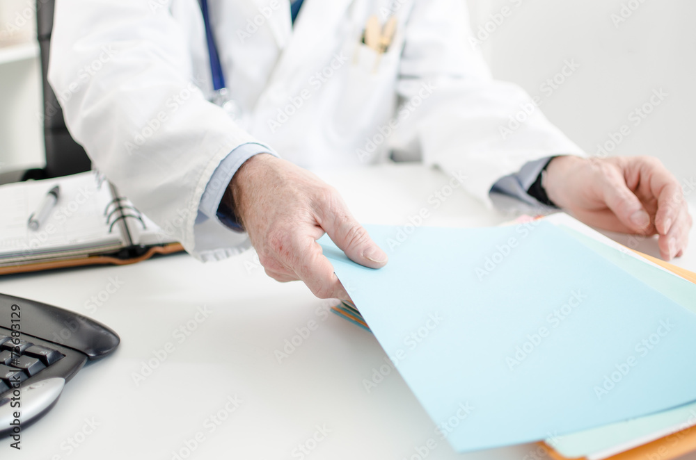 Doctor taking a file Doctor taking a file