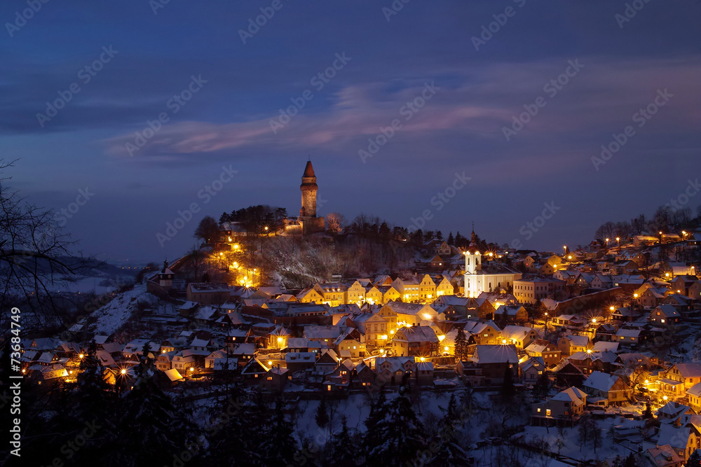 Illuminated old town on snowy Christmas evening