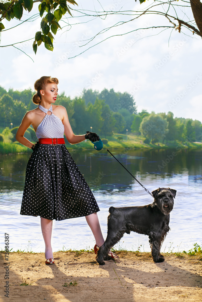 Beautiful girl with a Scottish Terrier in the Park Beautiful girl with a Scottish Terrier in the Park