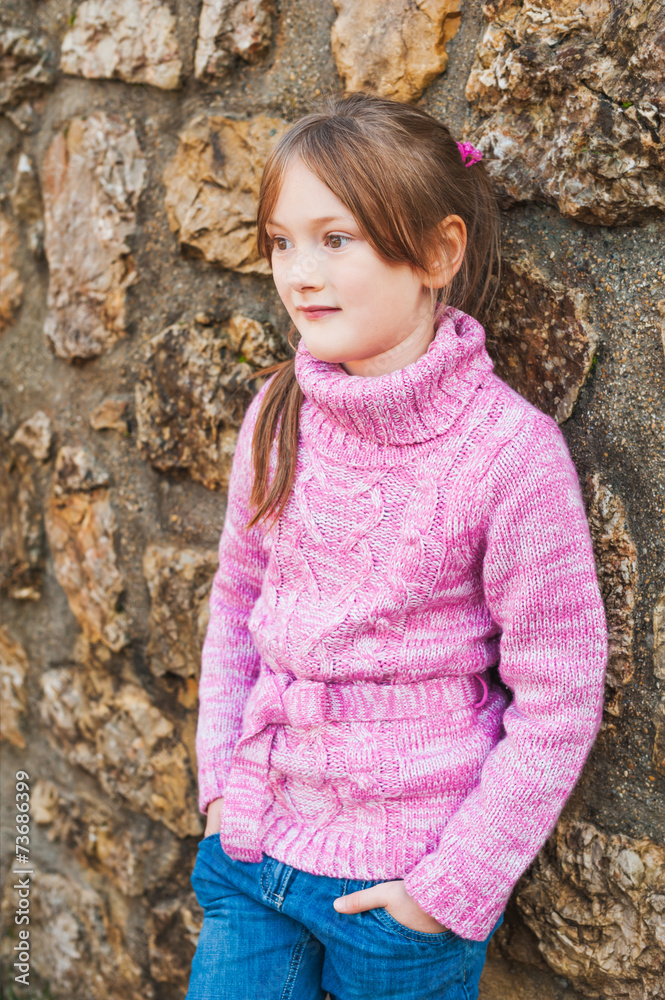 Outdoor portrait of adorable little girl wearing pink pullover Outdoor portrait of adorable little girl wearing pink pullover