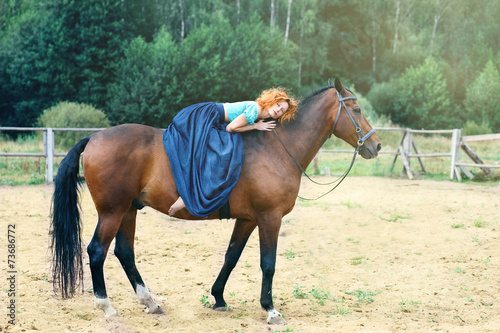 Girl in a beautiful dress on a horse