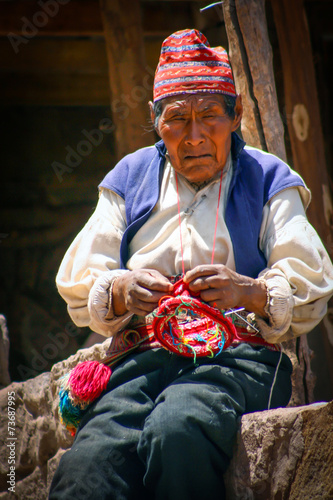 Old men knitting at taquile island in puno peru. photo