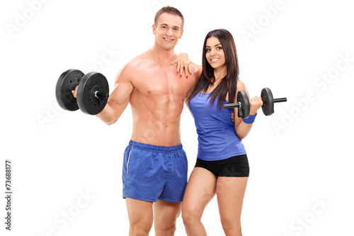 Couple of athletes posing with metal weights
