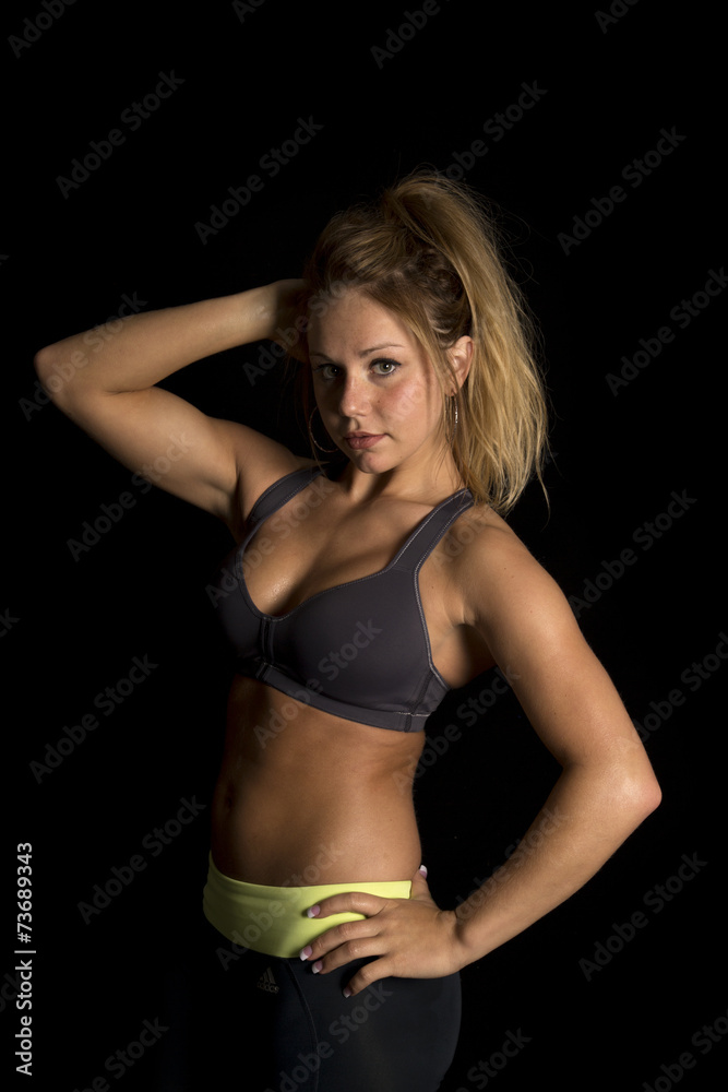 woman in black sports bra arms over head look Stock Photo