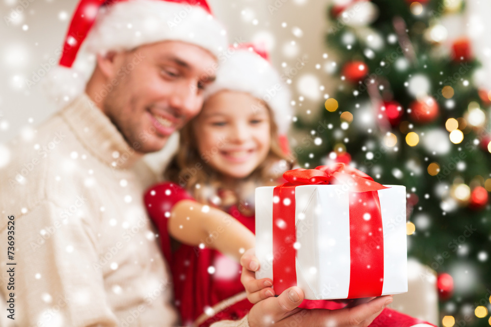 smiling father and daughter holding gift box