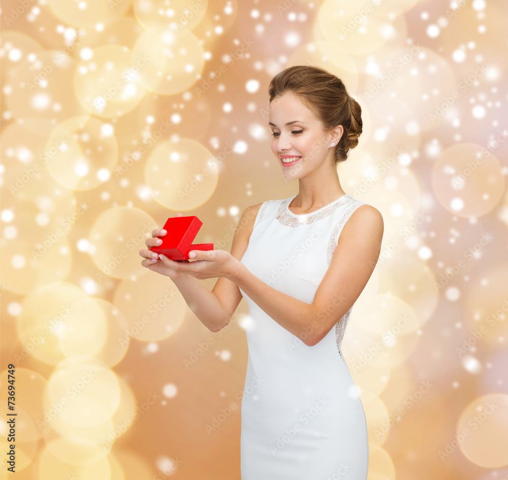 smiling woman holding red gift box smiling woman holding red gift box