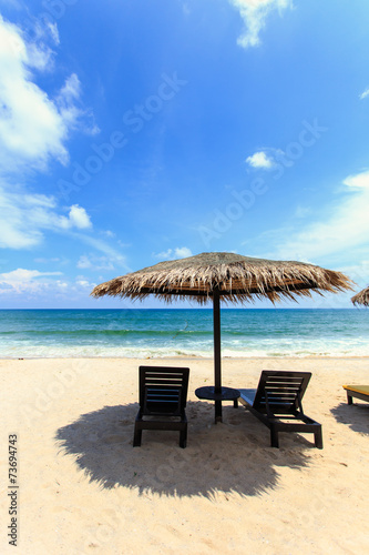 Sun umbrella and sun loungers stand at the beach in Phuket, Thai © SKT Studio